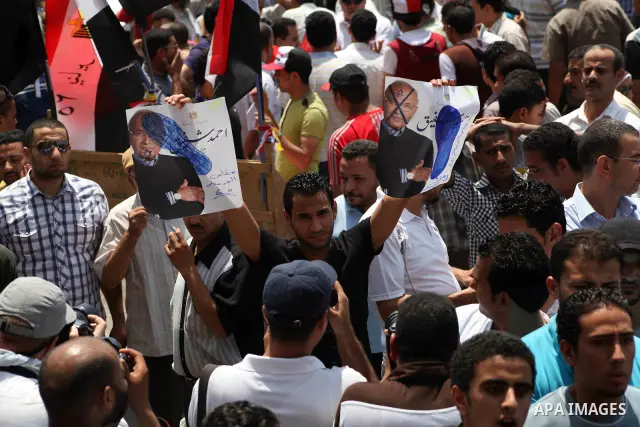 Egyptian protesters hold placards and shout slogans against the presidential candidate Ahmed Shafik, during a protest in Tahrir Square, Cairo, Egypt, 01 June 2012. Media reports state that hundreds of Egyptians held a de...