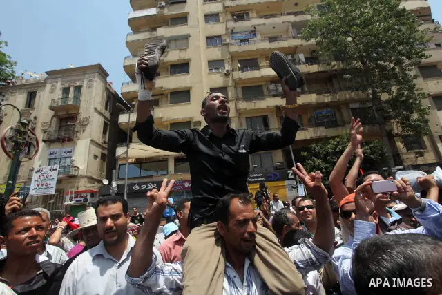 Egyptian protesters hold shoes and shout slogans against the presidential candidate Ahmed Shafik, during a protest in Tahrir Square, Cairo, Egypt, 01 June 2012. Media reports state that hundreds of Egyptians held a demon...