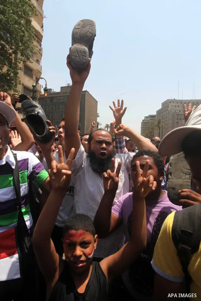 Egyptian protesters hold shoes and shout slogans against the presidential candidate Ahmed Shafik, during a protest in Tahrir Square, Cairo, Egypt, 01 June 2012. Media reports state that hundreds of Egyptians held a demon...
