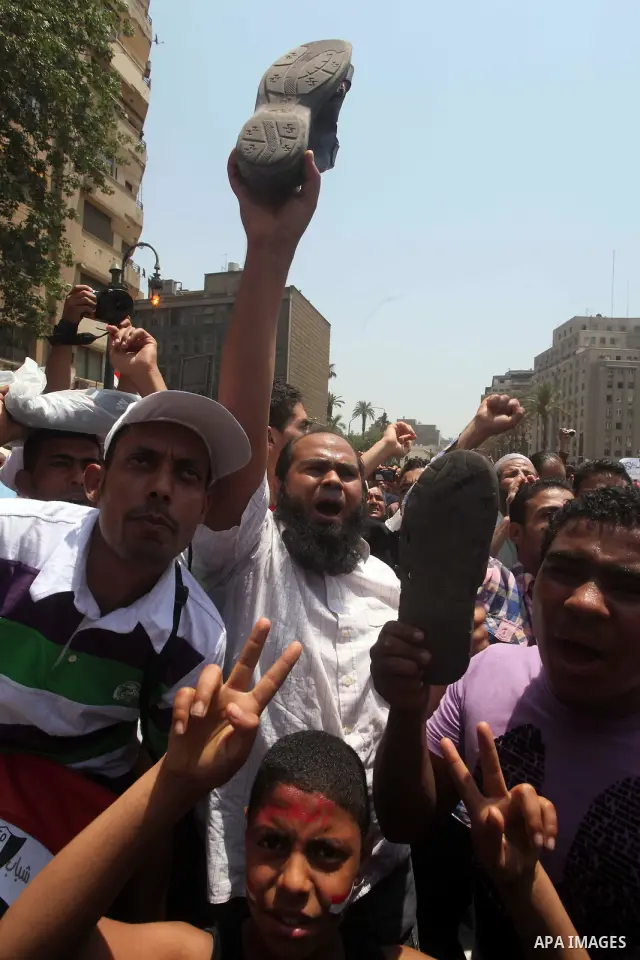 Egyptian protesters hold shoes and shout slogans against the presidential candidate Ahmed Shafik, during a protest in Tahrir Square, Cairo, Egypt, 01 June 2012. Media reports state that hundreds of Egyptians held a demon...