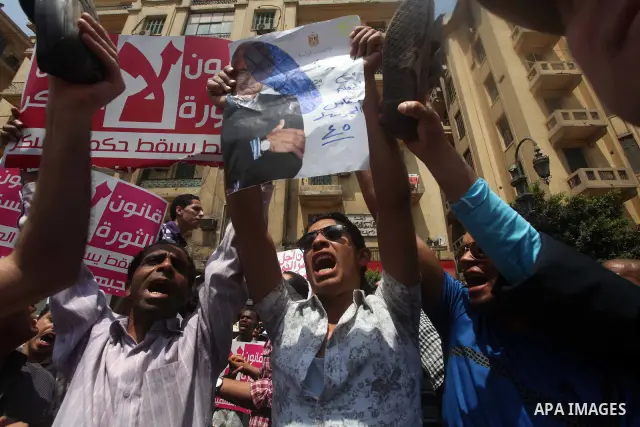 Egyptian protesters hold shoes and shout slogans against the presidential candidate Ahmed Shafik, during a protest in Tahrir Square, Cairo, Egypt, 01 June 2012. Media reports state that hundreds of Egyptians held a demon...