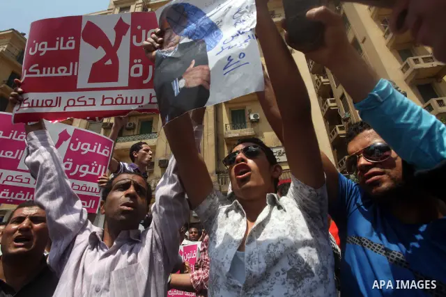 Egyptian protesters hold shoes and shout slogans against the presidential candidate Ahmed Shafik, during a protest in Tahrir Square, Cairo, Egypt, 01 June 2012. Media reports state that hundreds of Egyptians held a demon...