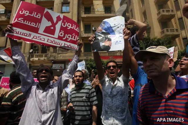 Egyptian protesters hold placards and shout slogans against the presidential candidate Ahmed Shafik, during a protest in Tahrir Square, Cairo, Egypt, 01 June 2012. Media reports state that hundreds of Egyptians held a de...