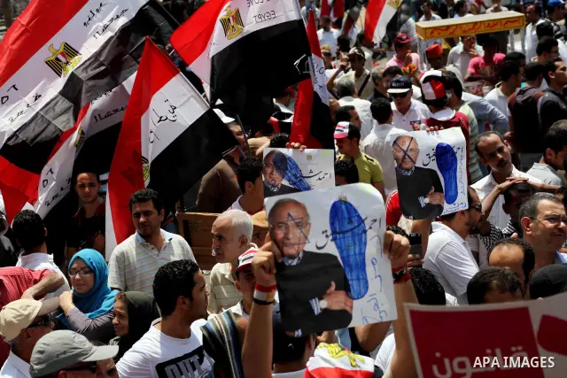 Egyptian protesters hold placards and shout slogans against the presidential candidate Ahmed Shafik, during a protest in Tahrir Square, Cairo, Egypt, 01 June 2012. Media reports state that hundreds of Egyptians held a de...