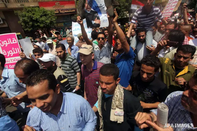 Egyptian protesters hold placards and shout slogans against the presidential candidate Ahmed Shafik, during a protest in Tahrir Square, Cairo, Egypt, 01 June 2012. Media reports state that hundreds of Egyptians held a de...