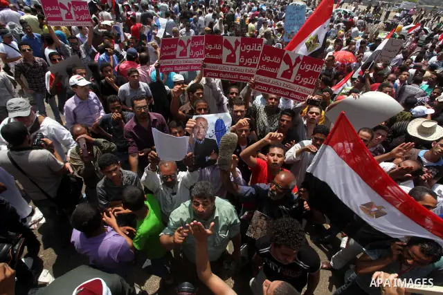 Egyptian protesters hold placards and shout slogans against the presidential candidate Ahmed Shafik, during a protest in Tahrir Square, Cairo, Egypt, 01 June 2012. Media reports state that hundreds of Egyptians held a de...