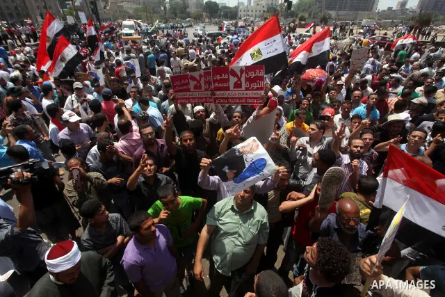 Egyptian protesters hold placards and shout slogans against the presidential candidate Ahmed Shafik, during a protest in Tahrir Square, Cairo, Egypt, 01 June 2012. Media reports state that hundreds of Egyptians held a de...