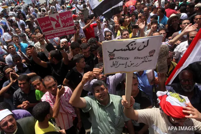 Egyptian protesters hold placards and shout slogans against the presidential candidate Ahmed Shafik, during a protest in Tahrir Square, Cairo, Egypt, 01 June 2012. Media reports state that hundreds of Egyptians held a de...