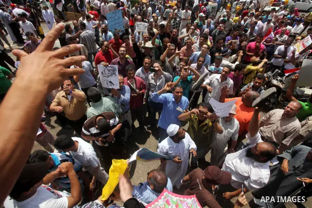 Egyptian protesters hold placards and shout slogans against the presidential candidate Ahmed Shafik, during a protest in Tahrir Square, Cairo, Egypt, 01 June 2012. Media reports state that hundreds of Egyptians held a de...