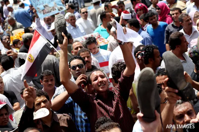 Egyptian protesters hold placards and shout slogans against the presidential candidate Ahmed Shafik, during a protest in Tahrir Square, Cairo, Egypt, 01 June 2012. Media reports state that hundreds of Egyptians held a de...