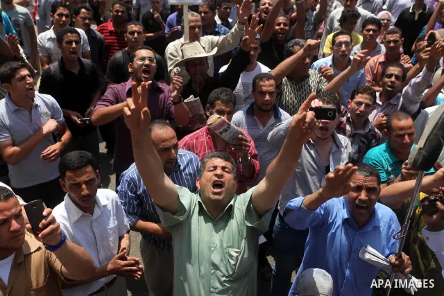 Egyptian protesters hold placards and shout slogans against the presidential candidate Ahmed Shafik, during a protest in Tahrir Square, Cairo, Egypt, 01 June 2012. Media reports state that hundreds of Egyptians held a de...