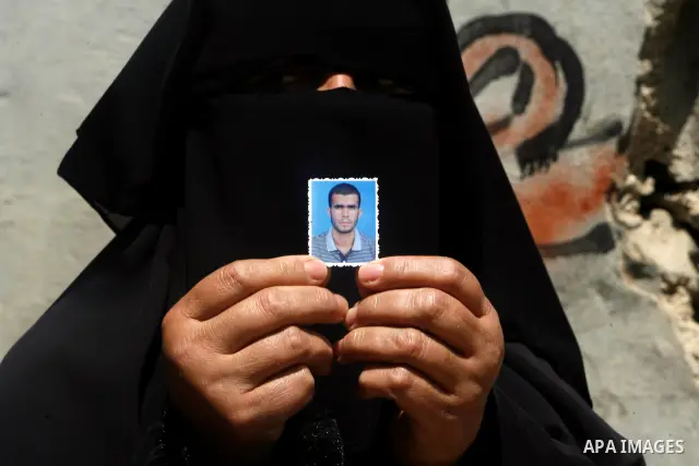 A relative of Ahmed Abu Nasr shows his photograph at his home in Khan Younis Refugee Camp, Friday, June 1, 2012. Abu Nasr and an Israeli soldier were killed in a shootout near the border with the Gaza Strip early Friday,...