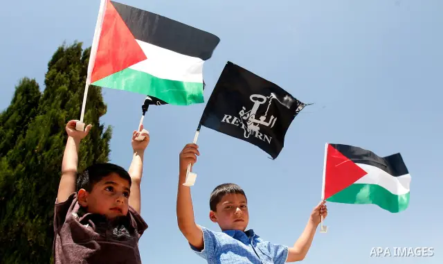 Palestinians hold national flag and shout slogans during a protest against continuing of 'Judaization of Jerusalem' by Jewish settlers and confiscating Palestinian lands at Al Tur and Damascus gate after Friday prayer in...