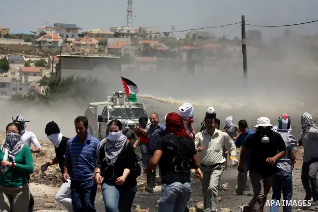 Israeli truck spray foul smelling water towards Palestinian protesters during a demonstration against the expropriation of Palestinian land by Israel in the village of Kafr Qaddum, near the West Bank city of Nablus on Ju...