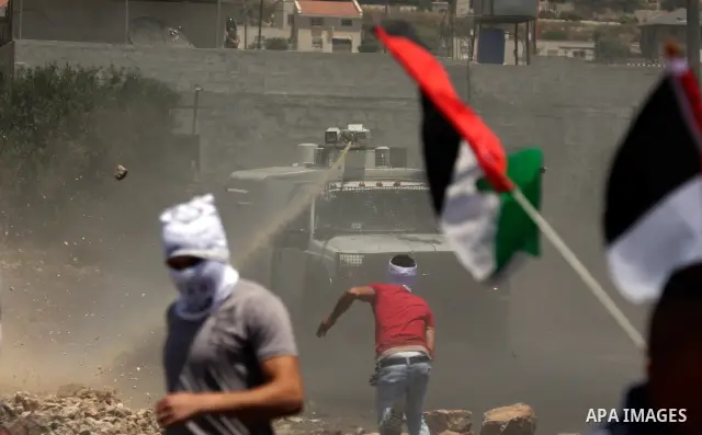 Israeli truck spray foul smelling water towards Palestinian protesters during a demonstration against the expropriation of Palestinian land by Israel in the village of Kafr Qaddum, near the West Bank city of Nablus on Ju...