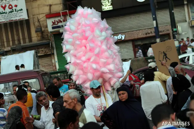 An Egyptian sells sweets during a demonstration against Egyptian presidential candidate Ahmed Shafiq in Tahrir Square decrying the result of the first round of voting in the Egyptian presidential election in Cairo, Egypt...