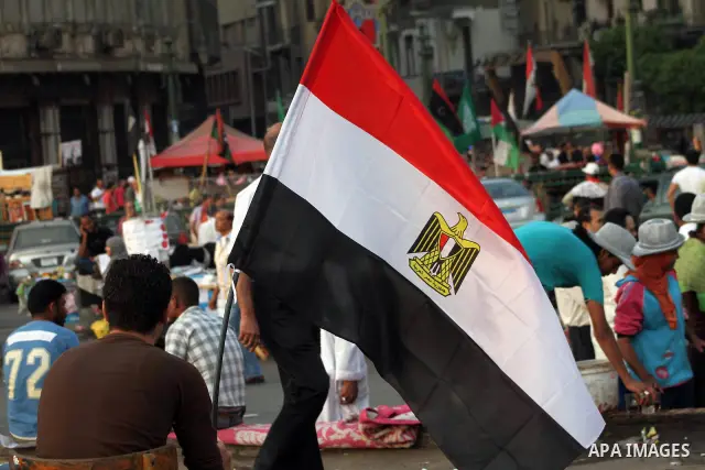 Egyptian protesters hold national flag during a demonstration against Egyptian presidential candidate Ahmed Shafiq in Tahrir Square decrying the result of the first round of voting in the Egyptian presidential election i...