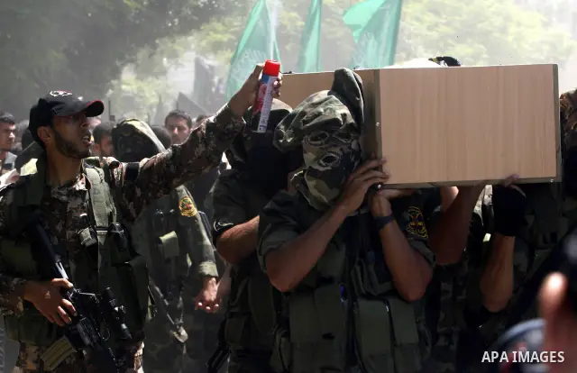 Islamic Jihad militants carry a flag-covered coffin containing the body of gunman Ahmed Nassir in Khan Younis in the southern Gaza Strip June 2, 2012. Nassir broke into Israel on Friday and killed a soldier before being...