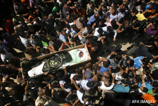 Palestinians carry a flag-covered coffin containing the body of gunman Ahmed Nassir in Khan Younis in the southern Gaza Strip June 2, 2012. Nassir broke into Israel on Friday and killed a soldier before being shot dead h...