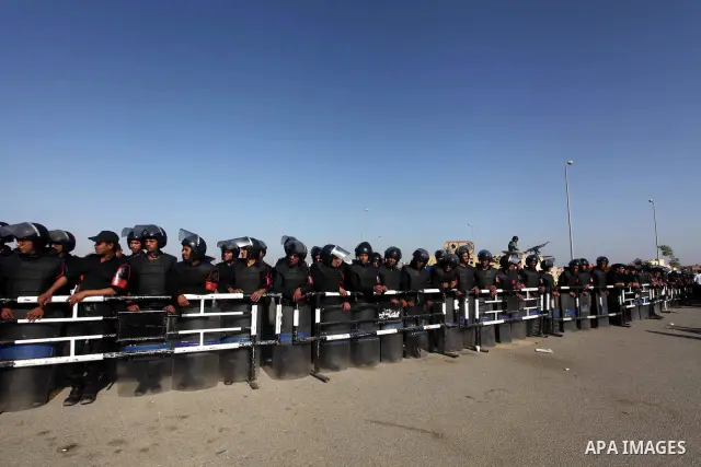 Egyptian riot police stand in front of the courthouse where ex-President Hosni Mubarak received a verdict in his trial for charges related to the death of protesters in Cairo, Egypt, Saturday, May 2, 2012. Egypt's ex-Pre...