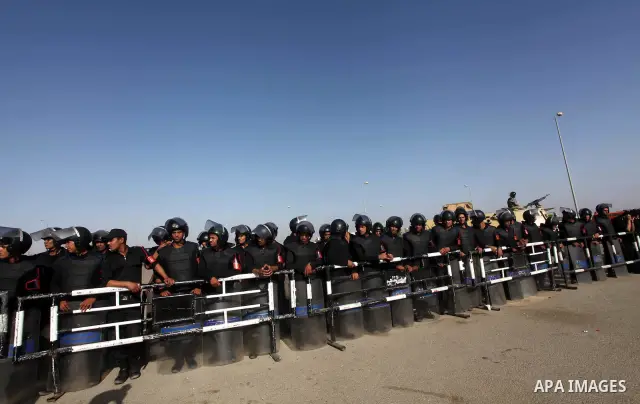 Egyptian riot police stand in front of the courthouse where ex-President Hosni Mubarak received a verdict in his trial for charges related to the death of protesters in Cairo, Egypt, Saturday, May 2, 2012. Egypt's ex-Pre...