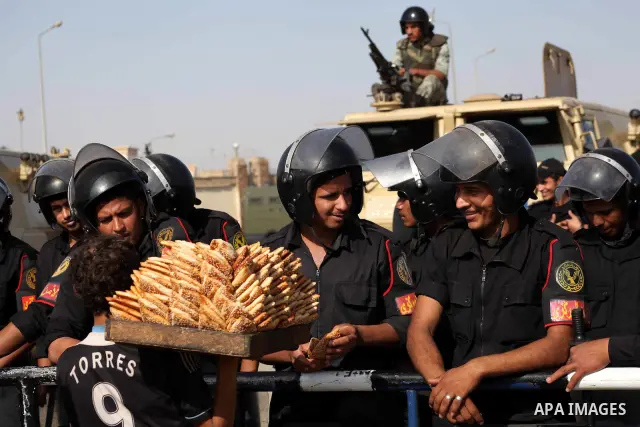 Egyptian riot police stand in front of the courthouse where ex-President Hosni Mubarak received a verdict in his trial for charges related to the death of protesters in Cairo, Egypt, Saturday, May 2, 2012. Egypt's ex-Pre...