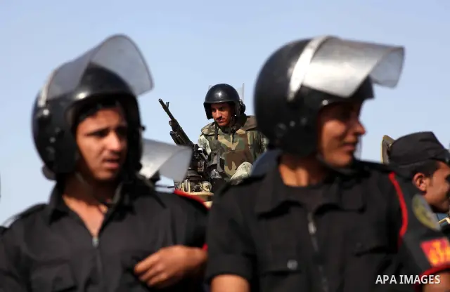 Egyptian riot police stand in front of the courthouse where ex-President Hosni Mubarak received a verdict in his trial for charges related to the death of protesters in Cairo, Egypt, Saturday, May 2, 2012. Egypt's ex-Pre...