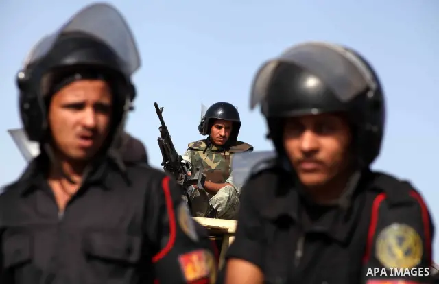 Egyptian riot police stand in front of the courthouse where ex-President Hosni Mubarak received a verdict in his trial for charges related to the death of protesters in Cairo, Egypt, Saturday, May 2, 2012. Egypt's ex-Pre...