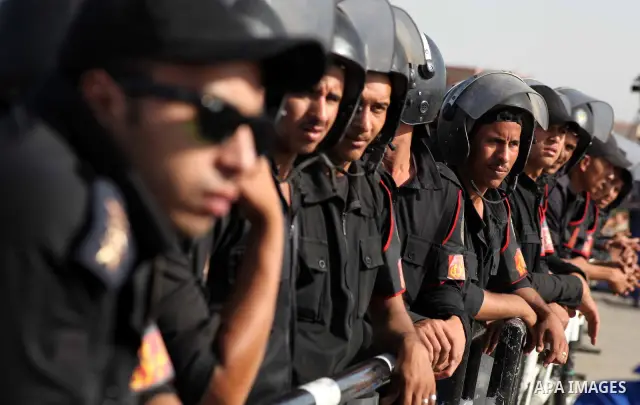 Egyptian riot police stand in front of the courthouse where ex-President Hosni Mubarak received a verdict in his trial for charges related to the death of protesters in Cairo, Egypt, Saturday, May 2, 2012. Egypt's ex-Pre...