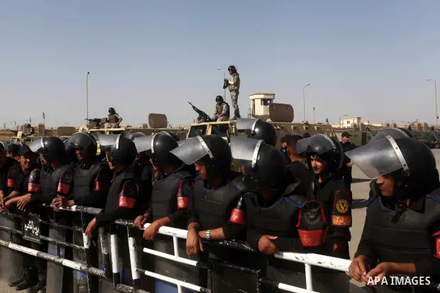 Egyptian riot police stand in front of the courthouse where ex-President Hosni Mubarak received a verdict in his trial for charges related to the death of protesters in Cairo, Egypt, Saturday, May 2, 2012. Egypt's ex-Pre...