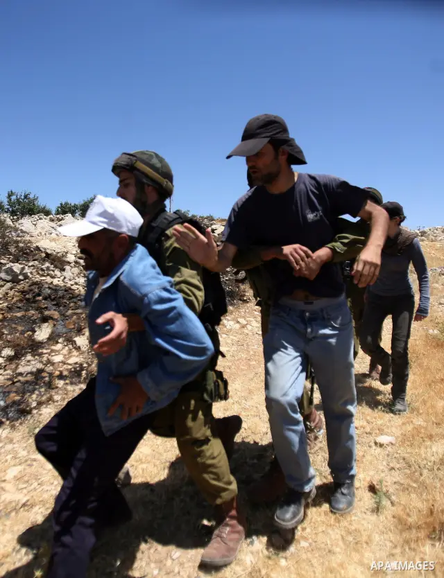 Israeli soldiers prevent Palestinians, left-wing Israeli and foreign peace activists from heading towards the Jewish settlement of Karim Tsor to protest against the confiscation of Palestinian land from the West Bank vil...