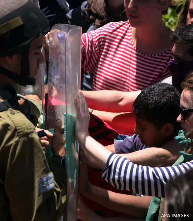 Israeli soldiers prevent Palestinians, left-wing Israeli and foreign peace activists from heading towards the Jewish settlement of Karim Tsor to protest against the confiscation of Palestinian land from the West Bank vil...