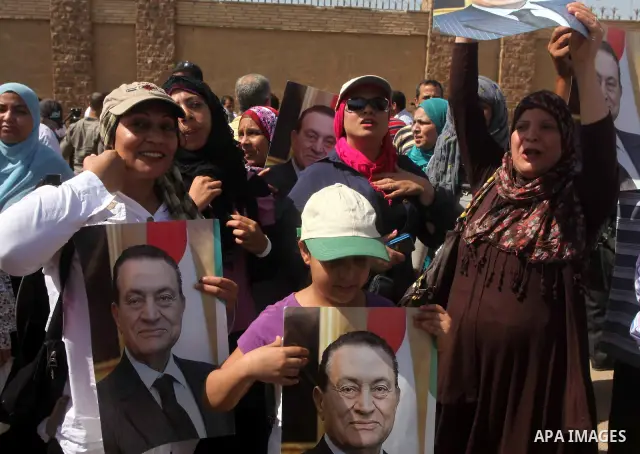 Supporters of deposed president Hosni Mubarak react after a court sentenced him to life in prison, outside the police academy where the court is located in Cairo June 2, 2012. Mubarak was sentenced to life in prison on S...