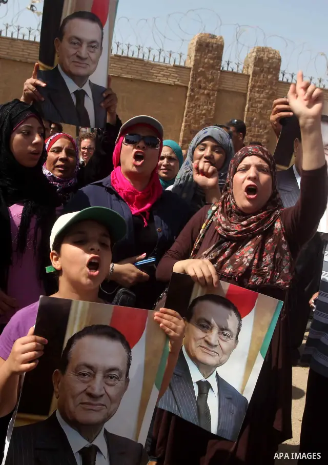 Supporters of deposed president Hosni Mubarak react after a court sentenced him to life in prison, outside the police academy where the court is located in Cairo June 2, 2012. Mubarak was sentenced to life in prison on S...