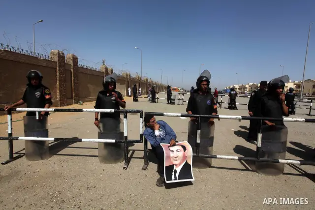 Supporters of deposed president Hosni Mubarak react after a court sentenced him to life in prison, outside the police academy where the court is located in Cairo June 2, 2012. Mubarak was sentenced to life in prison on S...