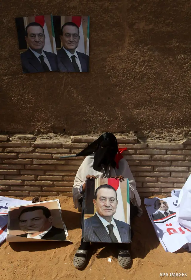Supporters of deposed president Hosni Mubarak react after a court sentenced him to life in prison, outside the police academy where the court is located in Cairo June 2, 2012. Mubarak was sentenced to life in prison on S...