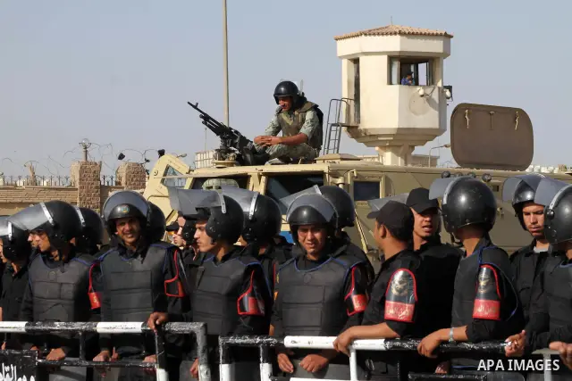 Egyptian riot police stand in front of the courthouse where ex-President Hosni Mubarak received a verdict in his trial for charges related to the death of protesters in Cairo, Egypt, Saturday, May 2, 2012. Egypt's ex-Pre...