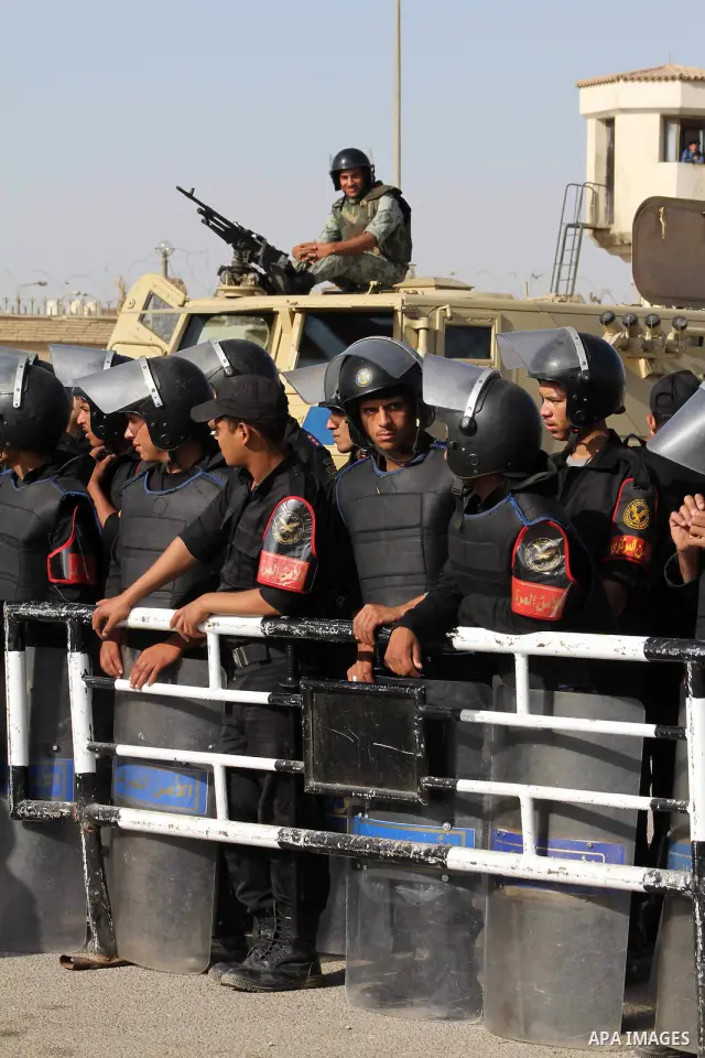 Egyptian riot police stand in front of the courthouse where ex-President Hosni Mubarak received a verdict in his trial for charges related to the death of protesters in Cairo, Egypt, Saturday, May 2, 2012. Egypt's ex-Pre...