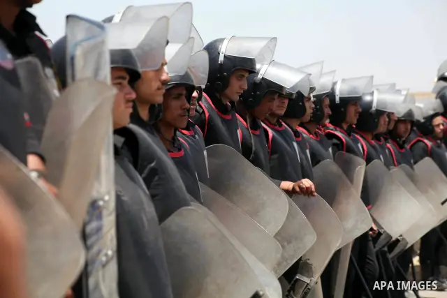 Egyptian riot police stand in front of the courthouse where ex-President Hosni Mubarak received a verdict in his trial for charges related to the death of protesters in Cairo, Egypt, Saturday, May 2, 2012. Egypt's ex-Pre...