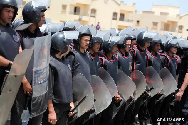 Egyptian riot police stand in front of the courthouse where ex-President Hosni Mubarak received a verdict in his trial for charges related to the death of protesters in Cairo, Egypt, Saturday, May 2, 2012. Egypt's ex-Pre...