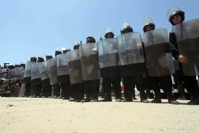 Egyptian riot police stand in front of the courthouse where ex-President Hosni Mubarak received a verdict in his trial for charges related to the death of protesters in Cairo, Egypt, Saturday, May 2, 2012. Egypt's ex-Pre...