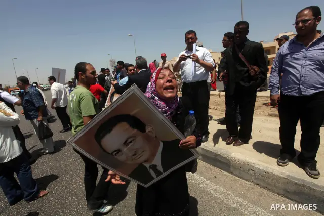 Supporters of deposed president Hosni Mubarak react after a court sentenced him to life in prison, outside the police academy where the court is located in Cairo June 2, 2012. Mubarak was sentenced to life in prison on S...