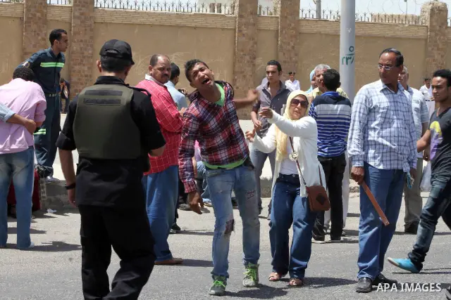 Supporters of deposed president Hosni Mubarak react after a court sentenced him to life in prison, outside the police academy where the court is located in Cairo June 2, 2012. Mubarak was sentenced to life in prison on S...