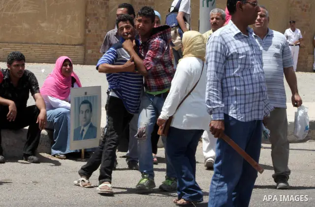 Supporters of deposed president Hosni Mubarak react after a court sentenced him to life in prison, outside the police academy where the court is located in Cairo June 2, 2012. Mubarak was sentenced to life in prison on S...