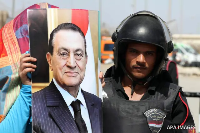 Supporters of deposed president Hosni Mubarak react after a court sentenced him to life in prison, outside the police academy where the court is located in Cairo June 2, 2012. Mubarak was sentenced to life in prison on S...