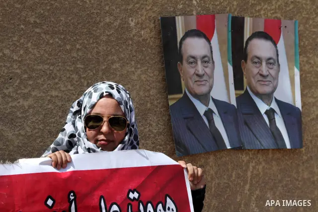 Supporters of deposed president Hosni Mubarak react after a court sentenced him to life in prison, outside the police academy where the court is located in Cairo June 2, 2012. Mubarak was sentenced to life in prison on S...