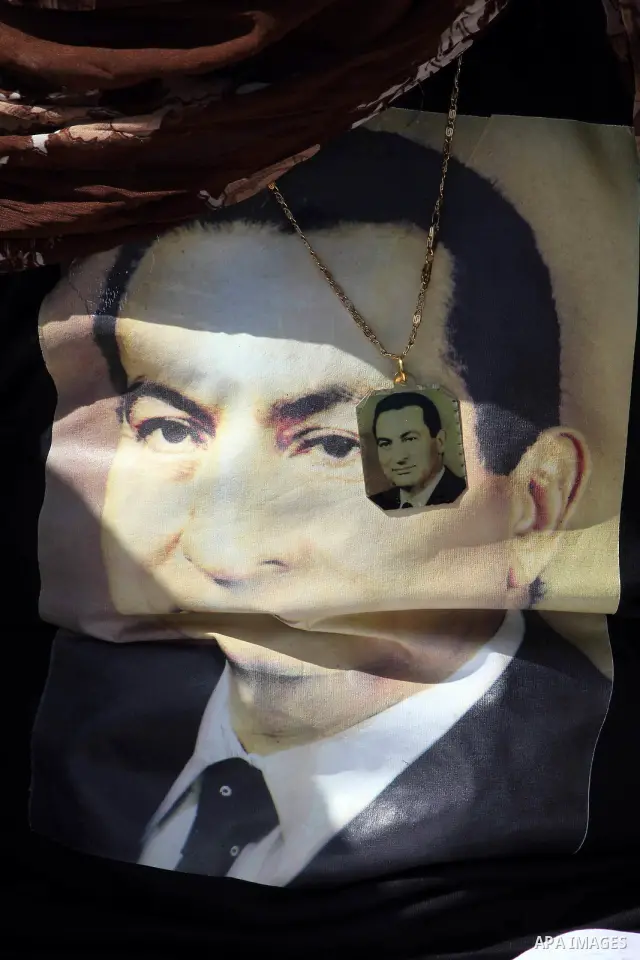 Supporters of deposed president Hosni Mubarak react after a court sentenced him to life in prison, outside the police academy where the court is located in Cairo June 2, 2012. Mubarak was sentenced to life in prison on S...