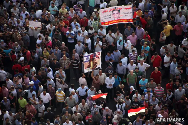 A view taken from a building overviewing Tahrir square shows Egyptian protesters shouting slogans against former President Hosni Mubarak and his aides during a demonstration hours after the announcement of the verdict in...