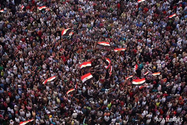 A view taken from a building overviewing Tahrir square shows Egyptian protesters shouting slogans against former President Hosni Mubarak and his aides during a demonstration hours after the announcement of the verdict in...