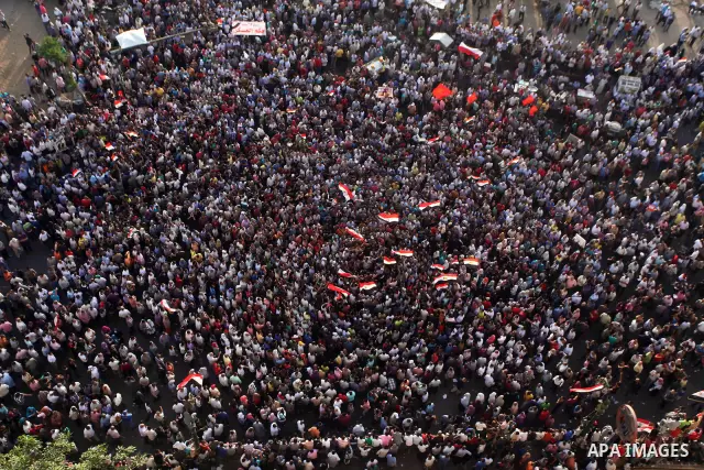 A view taken from a building overviewing Tahrir square shows Egyptian protesters shouting slogans against former President Hosni Mubarak and his aides during a demonstration hours after the announcement of the verdict in...